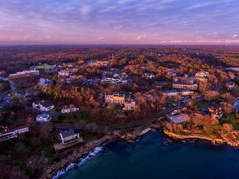 aerial shot of endicott campus including ocean during sunrise/sunset