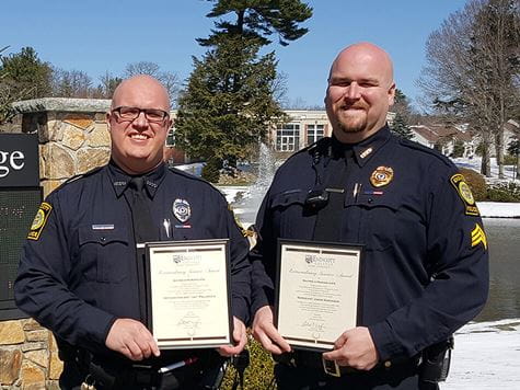 two endicott cops holding up certificates